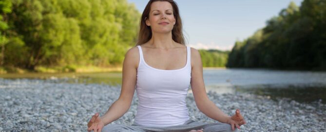 Woman sitting peacefully in calm natural light representing anxiety relief through therapy at Sunflower Counseling Montana
