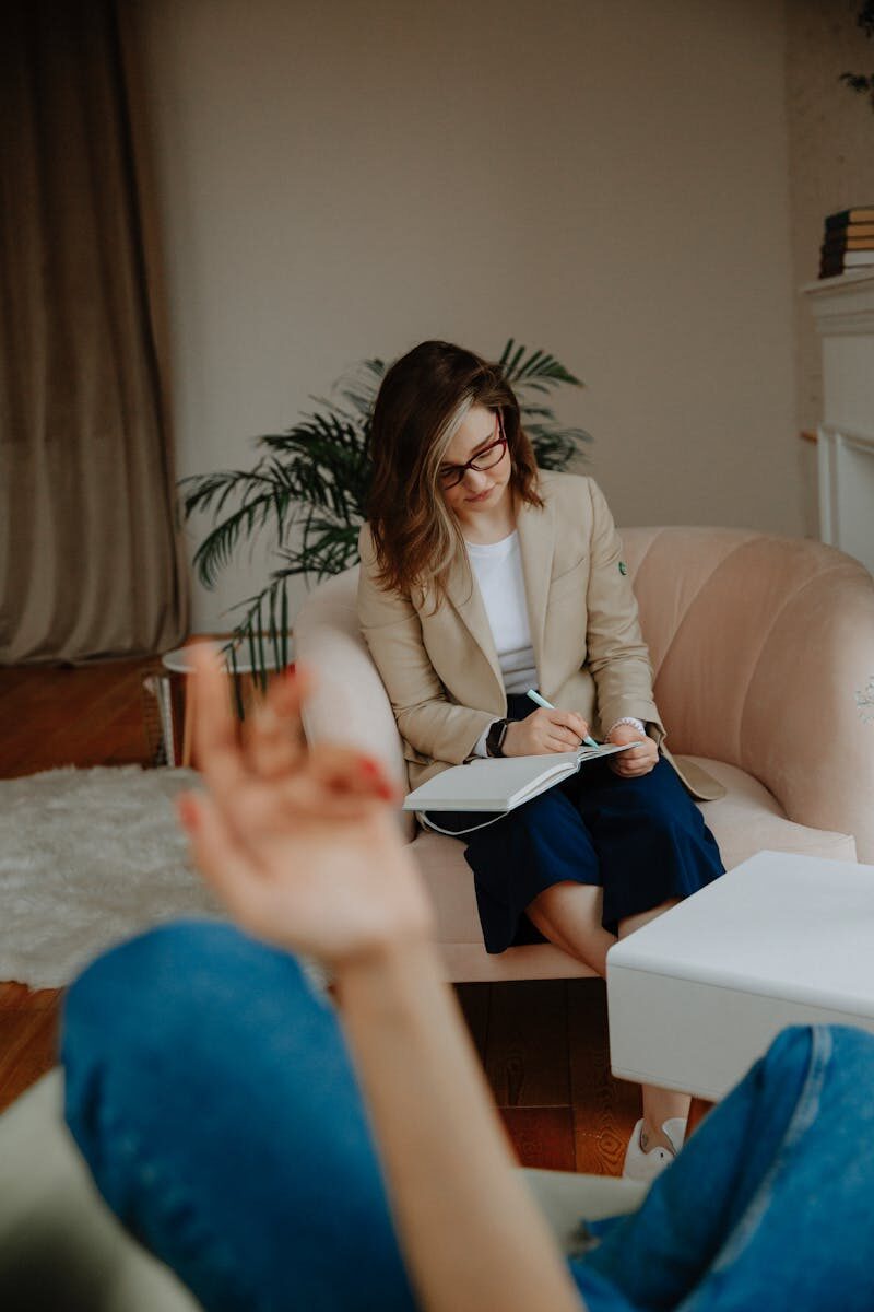 A therapist in a warm office setting listening attentively during an anxiety therapy session in Montana